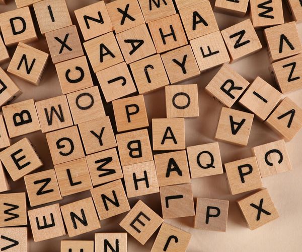 A compass pointing towards the word 'balance' on a dark, textured background.